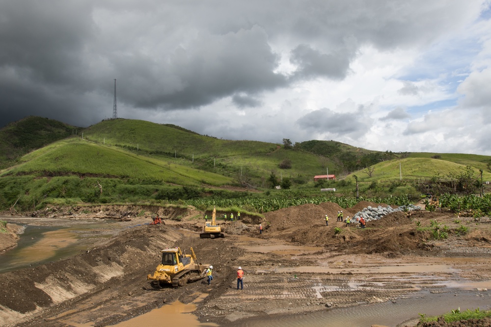 Workers and Earthmoving Machines Build Emergency Levee, Puerto Rico