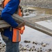 Worker Carries Surveying Stakes during USACE Emergency Levee Project, Puerto Rico