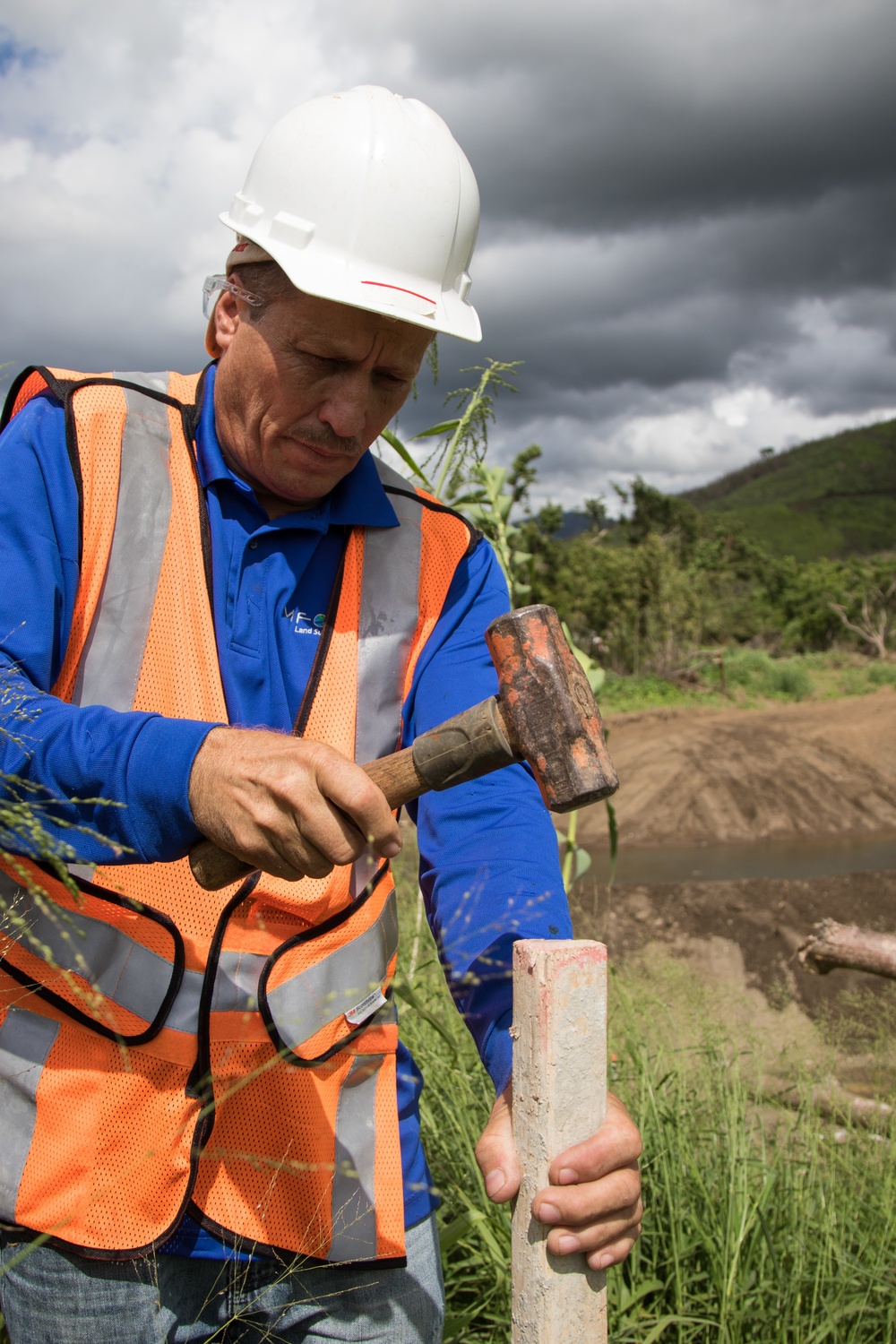 Worker Places Surveying Stakes during USACE Emergency Levee Project, Puerto Rico