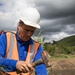 Worker Places Surveying Stakes during USACE Emergency Levee Project, Puerto Rico