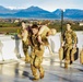 Paratroopers fireman carry dummies during The Brostrom Challenge