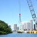 Crews lift a sailing vessel out of Biscayne Bay