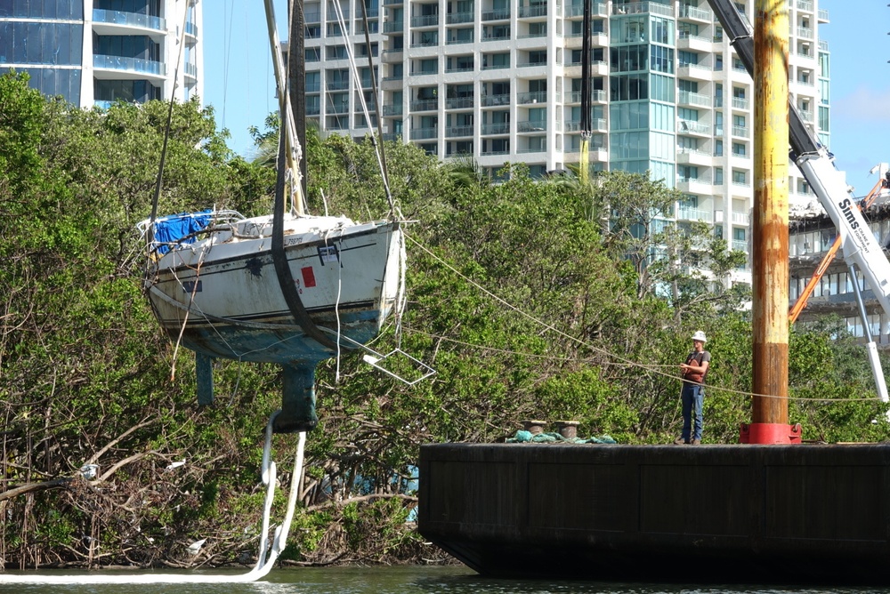 Response crews remove a sailing vessel from red mangroves at Peacock Park