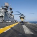 USS America Sailor signals aircraft to lift off