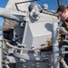 Sailor loads Mark 38 25 mm machine gun