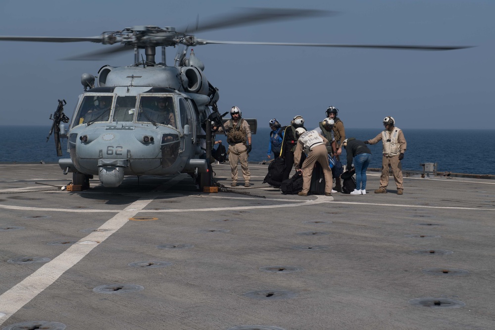 USS Pearl Harbor flight deck personnel launch and recover helicopters