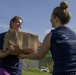 Volunteer Passes Box of Groceries