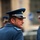 NATO Military Committee visit to Sarajevo A male military officer in a blue dress uniform is photographed from behind as he turns his head to the right. He is wearing a peaked cap with a gold badge and silver braided band, and his shoulder epaulette displays two white stars. Additional uniformed personnel are visible in the blurred background.