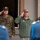NATO Military Committee visit to Sarajevo Two military officers are rendering salutes during what appears to be a formal military ceremony. The officer on the right wears a US Air Force uniform with the name tape 'HUSTON' and a single star insignia indicating a Brigadier General rank, while the officer on the left wears a woodland camouflage uniform with the name tape 'MAROVIC' or similar. Personnel in light blue uniforms are visible in the foreground, suggesting an honor guard or ceremonial unit.