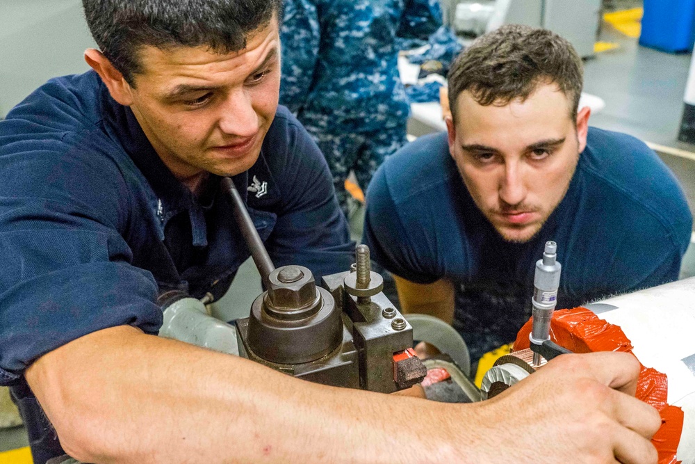 USS EMORY S. LAND Sailors build a priming pump for USS Michigan