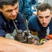 USS EMORY S. LAND Sailors build a priming pump for USS Michigan