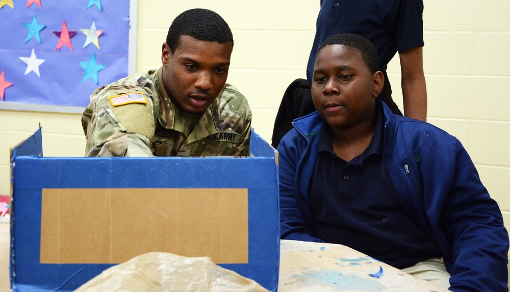 A Soldier helps MacArthur Middle School students with history projects