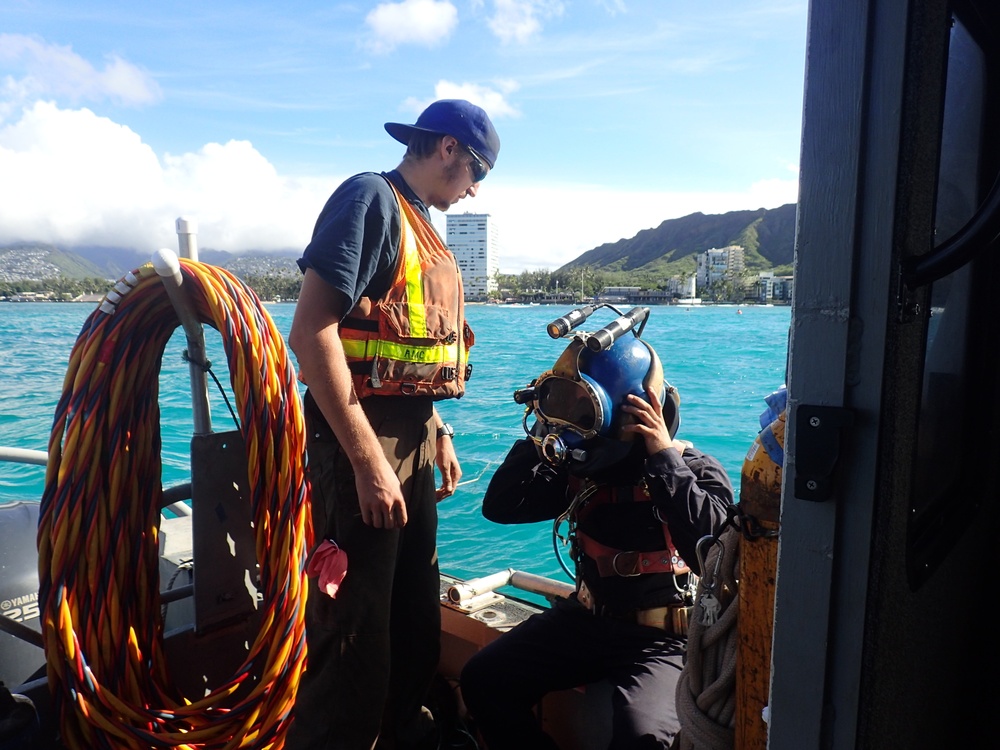 Responders prepare diver during Pacific Paradise wreck removal efforts