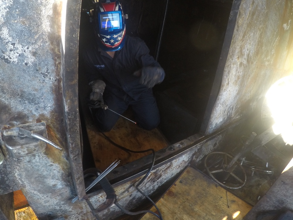 Welders install walkway aboard Pacific Paradise