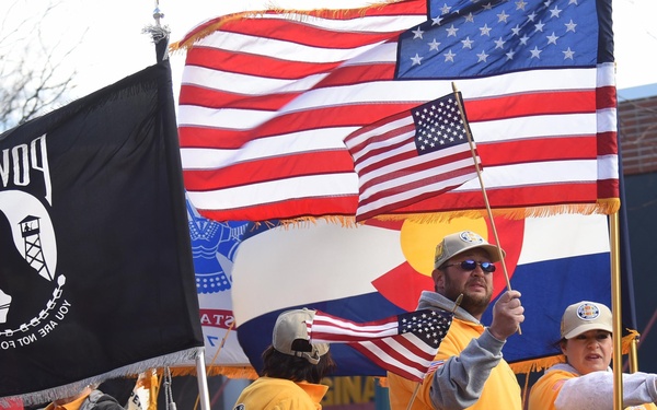 Flags flow, Opinicus stands tall during parade