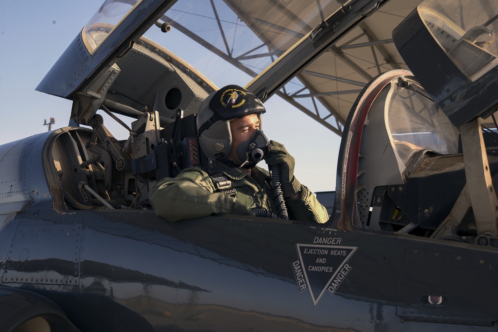 Vance instructor pilot communicates with student pilot