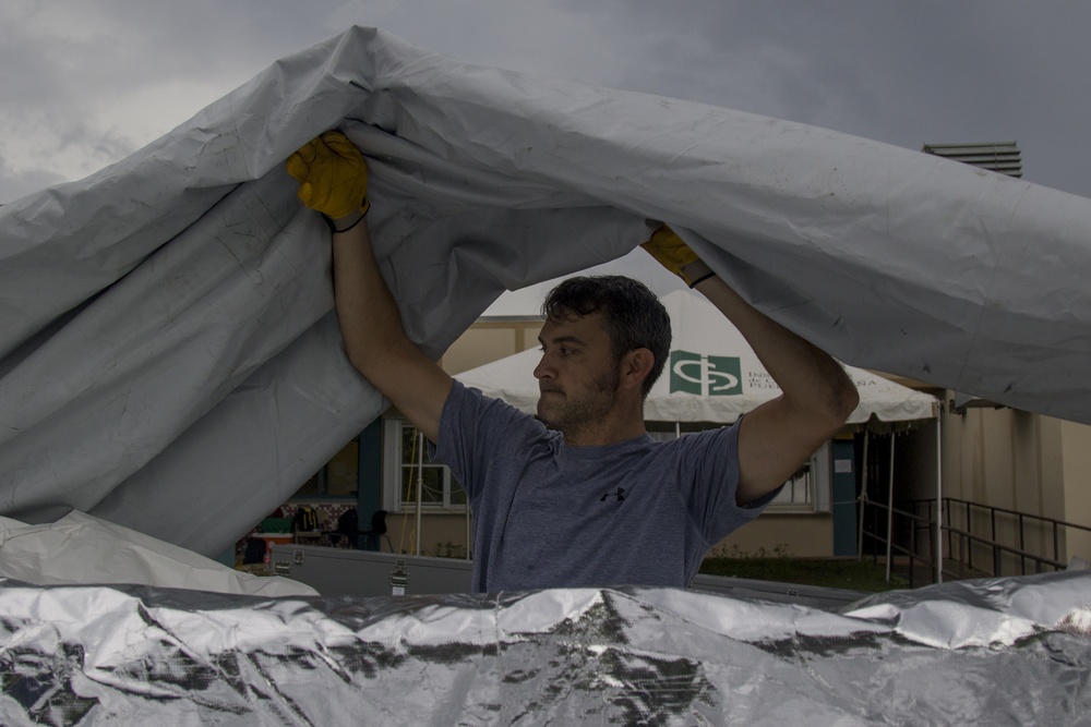 DMAT Personnel Installs Tent Roof