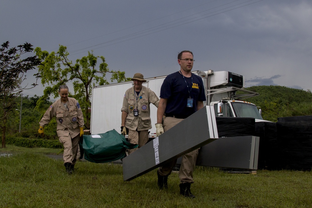 DMAT Personnel Carries Tent Pieces