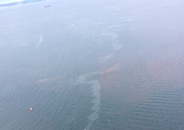 Coast Guard helicopter crew shows location of sunken vessel and oil sheen near Shilshole Bay Marina in Seattle
