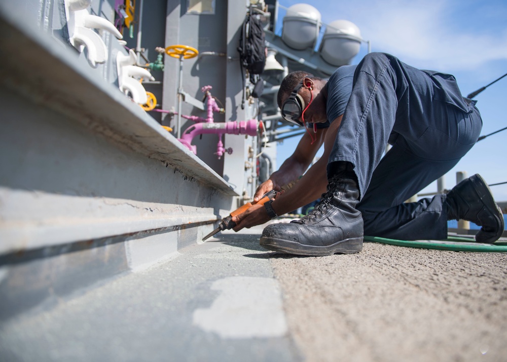 USS Lake Erie (CG 70) BM3 conducts deck preservation