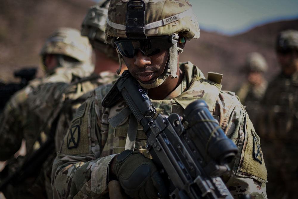 Soldiers conduct live fire shoot house training
