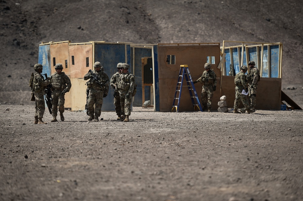 Soldiers conduct live fire shoot house training