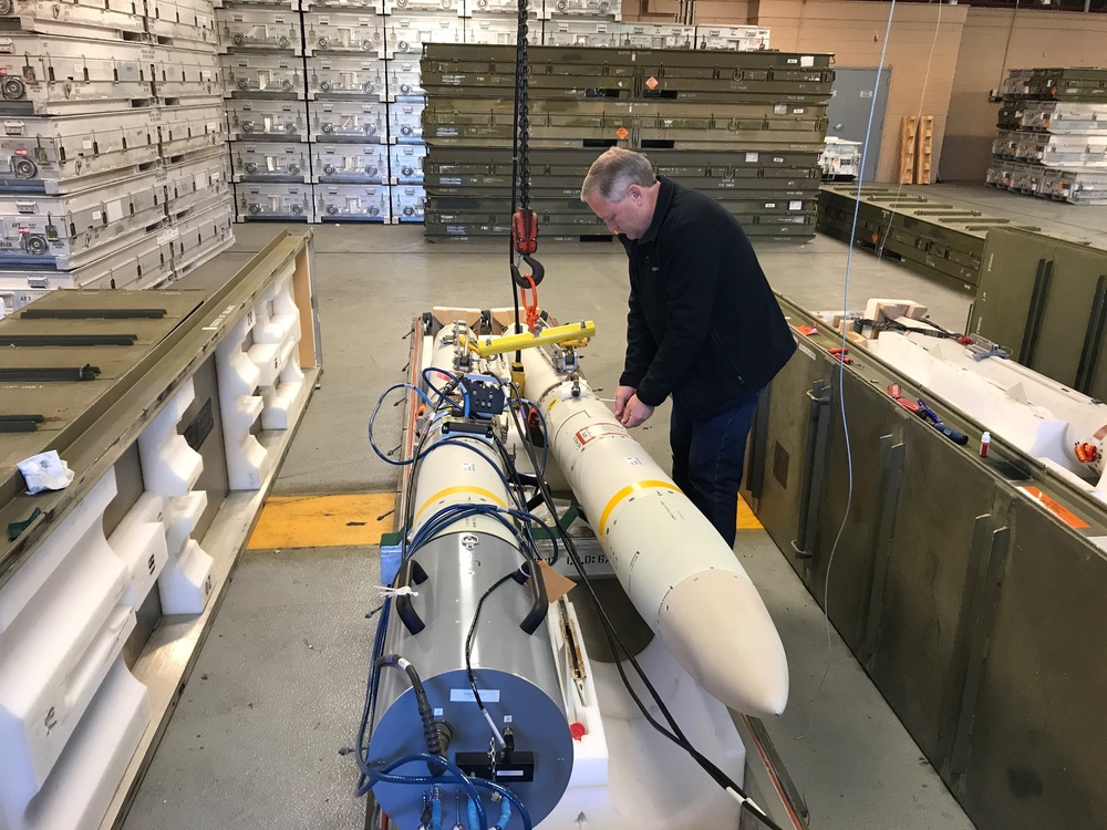 A Letterkenny Munitions Center technician prepares an Advanced Anti-Radiation Guided Missile for testing onsite.