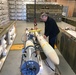 A Letterkenny Munitions Center technician prepares an Advanced Anti-Radiation Guided Missile for testing onsite.
