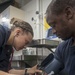 USS America Sailor checks patient’s blood pressure