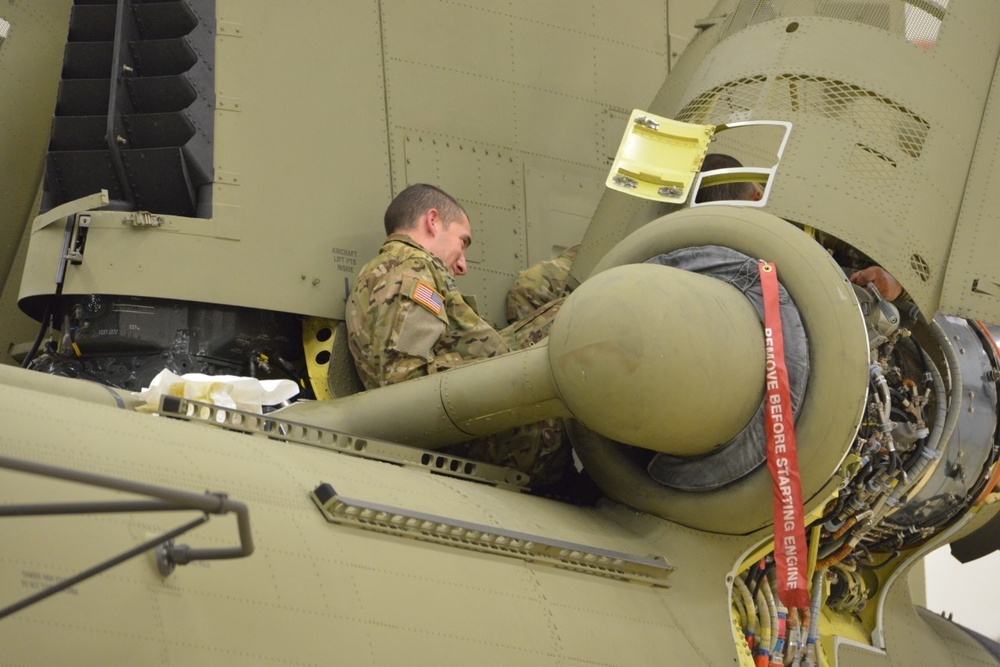 Soldier performing maintenance on a Chinook engine