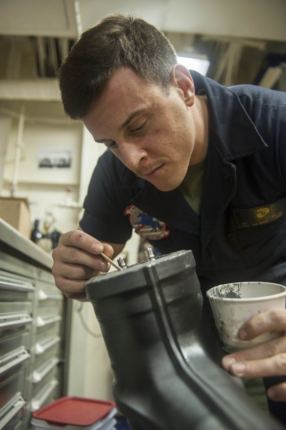 USS America Marine conducts aircraft maintenance
