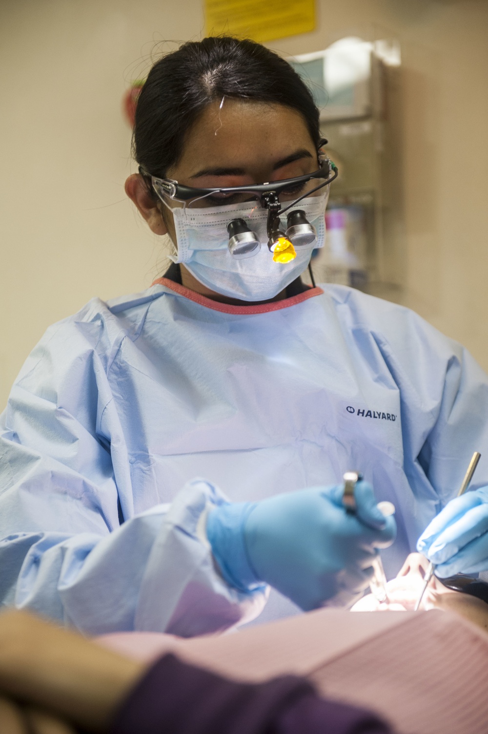 USS America Sailor conducts dental cleaning