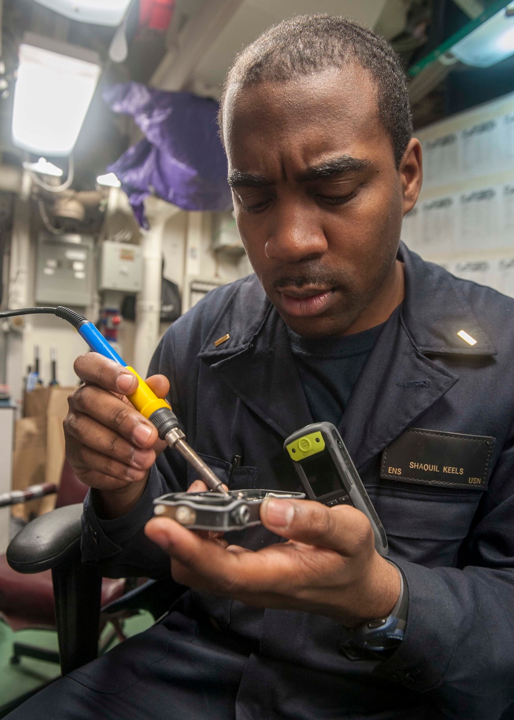 USS America Sailor assembles integrated voice network phone