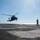 USS America Sailor signals helicopter for landing