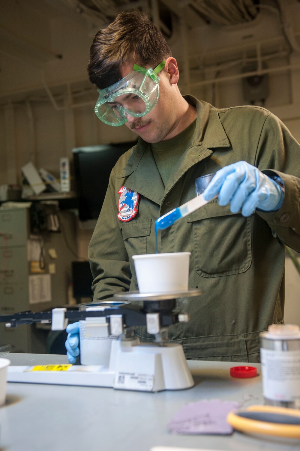 USS America Sailor mixes resin for composite repairs