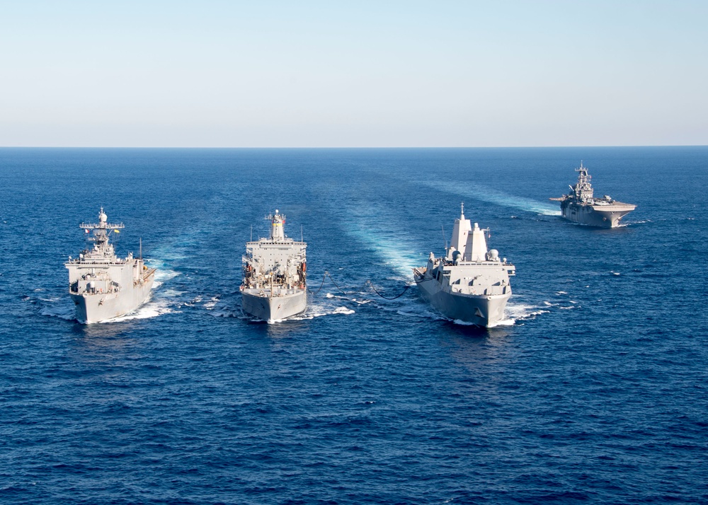 The amphibious transport dock ship USS New York (LPD 21), left, and the amphibious dock landing ship USS Oak Hill (LSD 51), right, receive fuel from the fleet replenishment oiler USNS Big Horn (T-AO 198) during a replenishment-at-sea