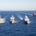 The amphibious transport dock ship USS New York (LPD 21), left, and the amphibious dock landing ship USS Oak Hill (LSD 51), right, receive fuel from the fleet replenishment oiler USNS Big Horn (T-AO 198) during a replenishment-at-sea