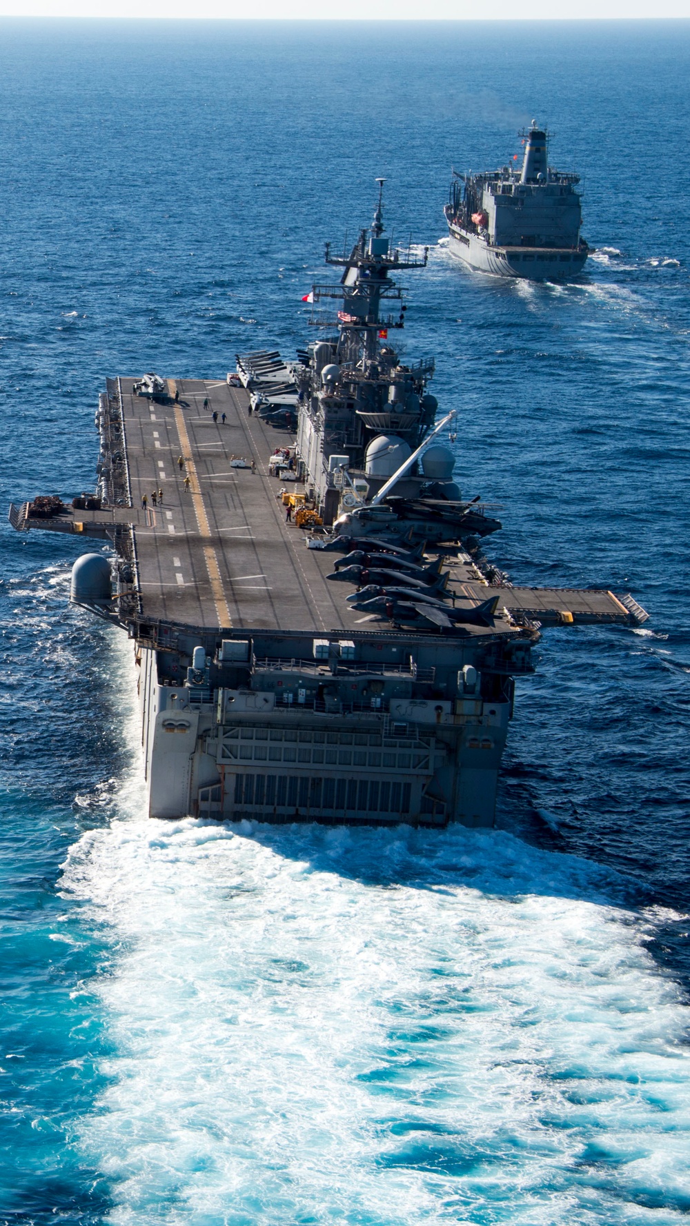 The amphibious transport dock ship USS New York (LPD 21), left, and the amphibious dock landing ship USS Oak Hill (LSD 51), right, receive fuel from the fleet replenishment oiler USNS Big Horn (T-AO 198) during a replenishment-at-sea