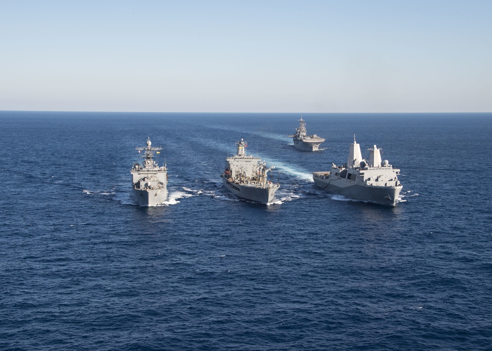 The amphibious transport dock ship USS New York (LPD 21), left, and the amphibious dock landing ship USS Oak Hill (LSD 51), right, receive fuel from the fleet replenishment oiler USNS Big Horn (T-AO 198) during a replenishment-at-sea