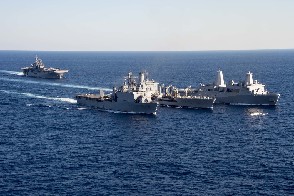 The amphibious transport dock ship USS New York (LPD 21), left, and the amphibious dock landing ship USS Oak Hill (LSD 51), right, receive fuel from the fleet replenishment oiler USNS Big Horn (T-AO 198) during a replenishment-at-sea