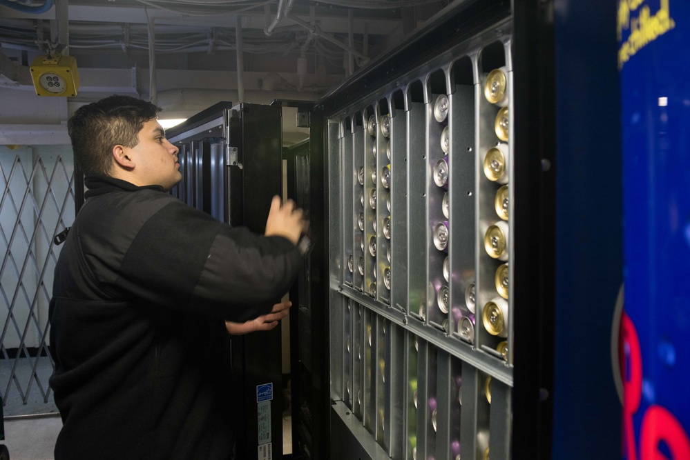 Sailor restocks vending machine