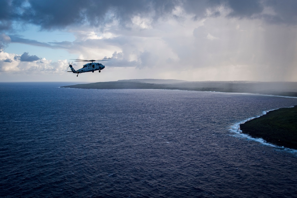 HSC-25 Helicopter Flies Over Tinian