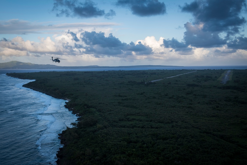 HSC-25 Helicopter Flies Over Tinian