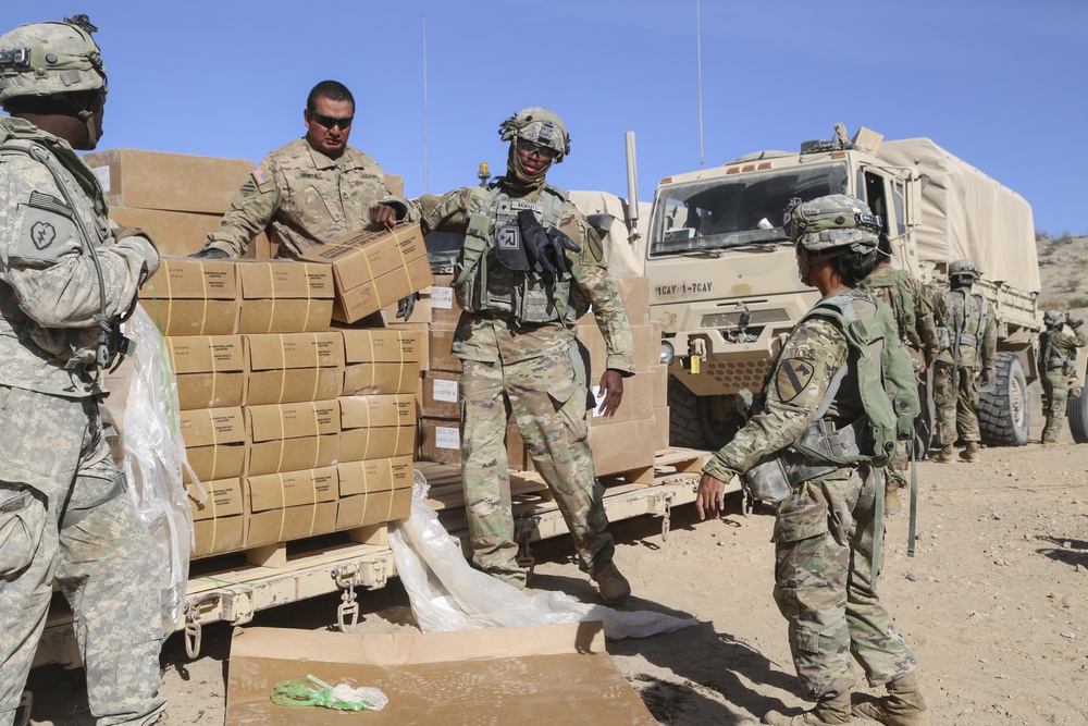 U.S. Army soldiers assigned to 1st Squadron, 7th Cavalry Regiment, 1st Brigade Combat Team, 1st Cavalry Division, distribute Meals Ready to Eat