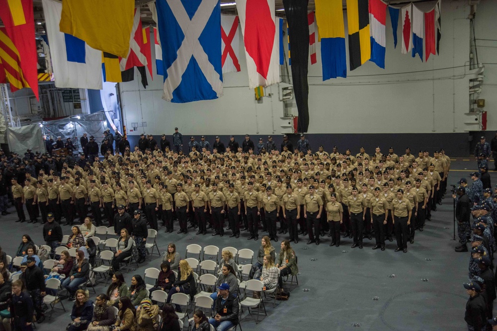 Sailors participate in a frocking ceremony.