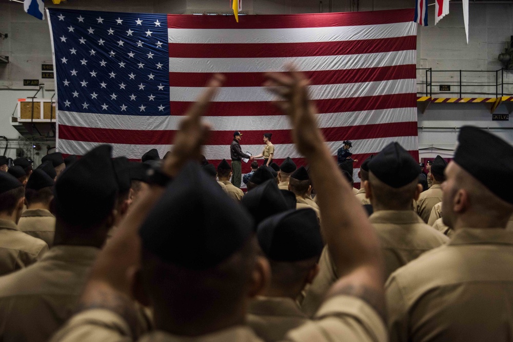 Sailors participate in a frocking ceremony.