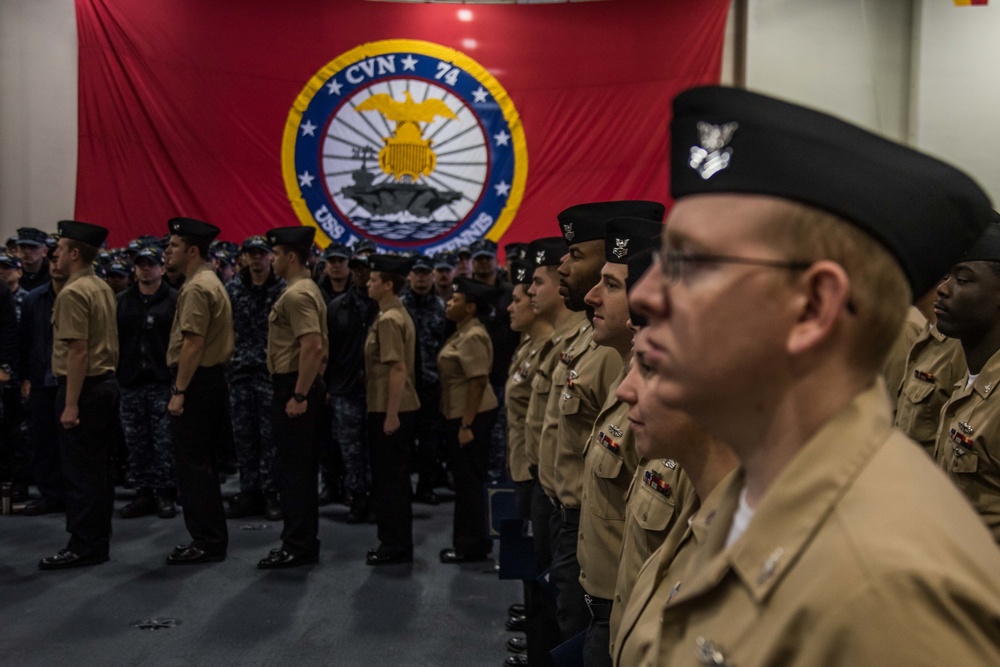 Sailors participate in a frocking ceremony.
