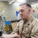 USS America Sailor checks patient’s blood pressure