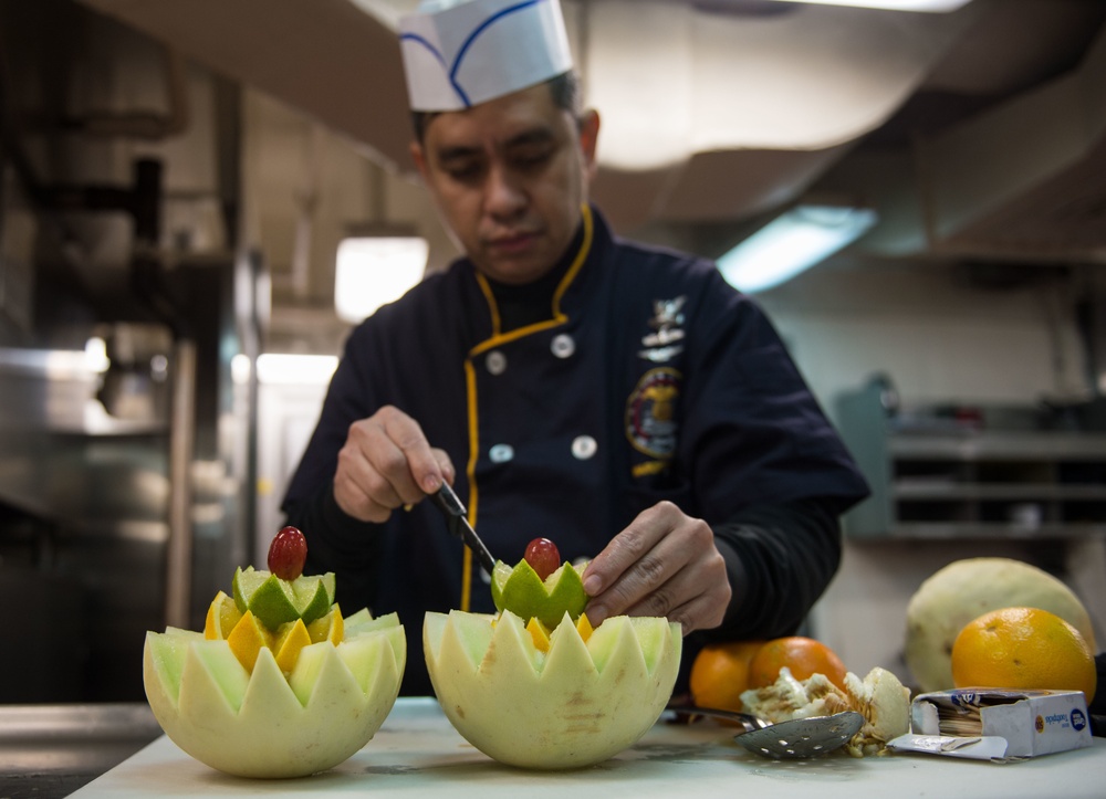 John C. Stennis Sailor carves fruit