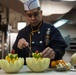 John C. Stennis Sailor carves fruit